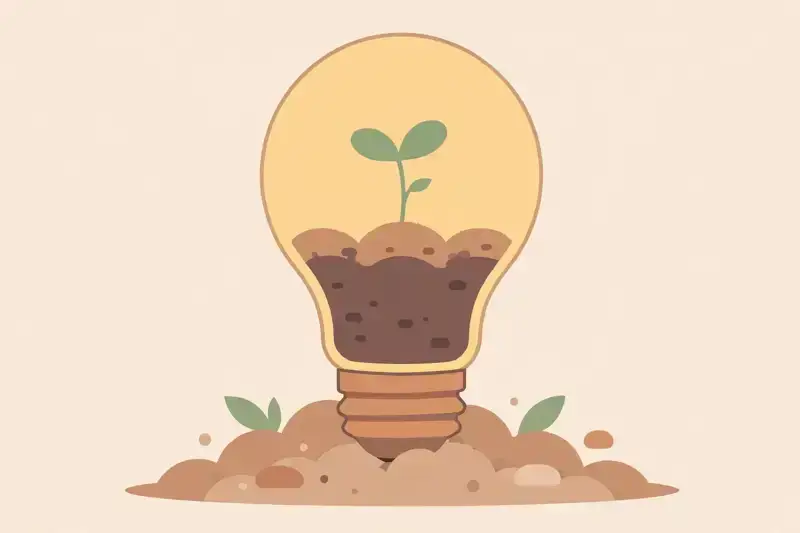 A seedling sprouting from a lightbulb planted in soil